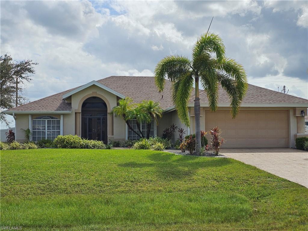 a front view of house with yard and green space