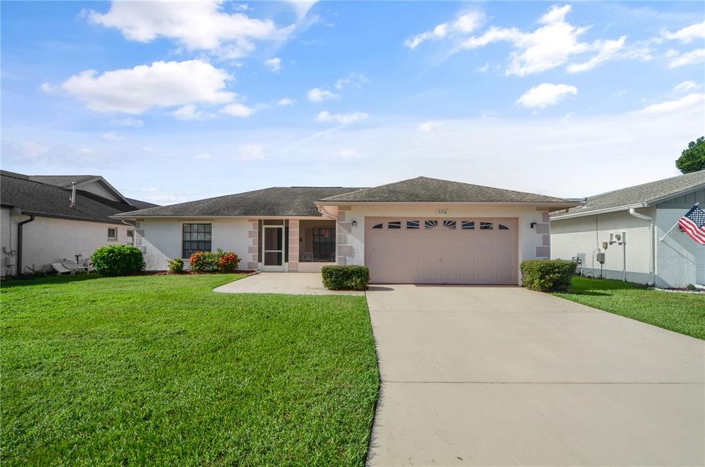 a front view of a house with a yard and garage