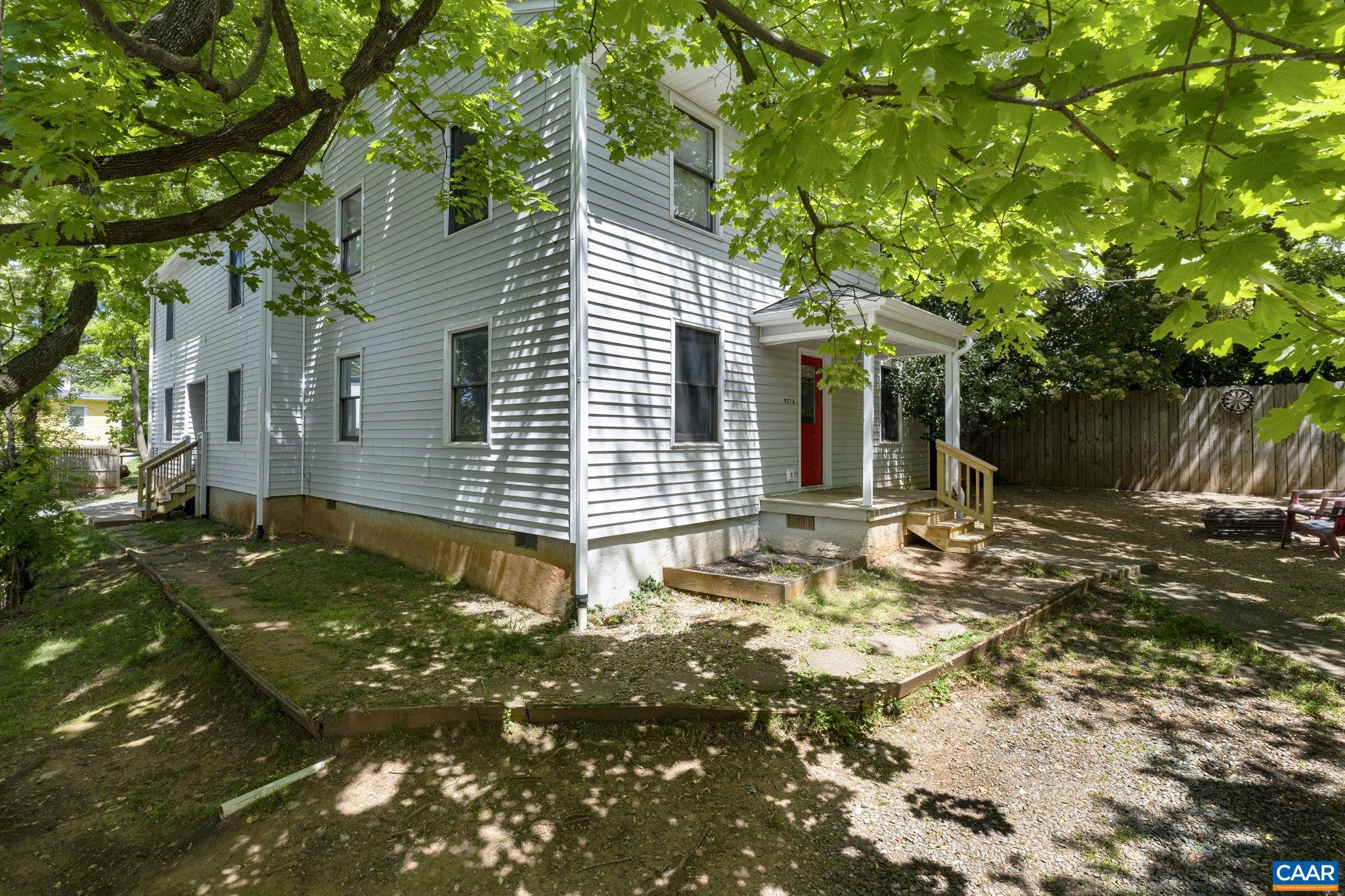 a backyard of a house with table and chairs