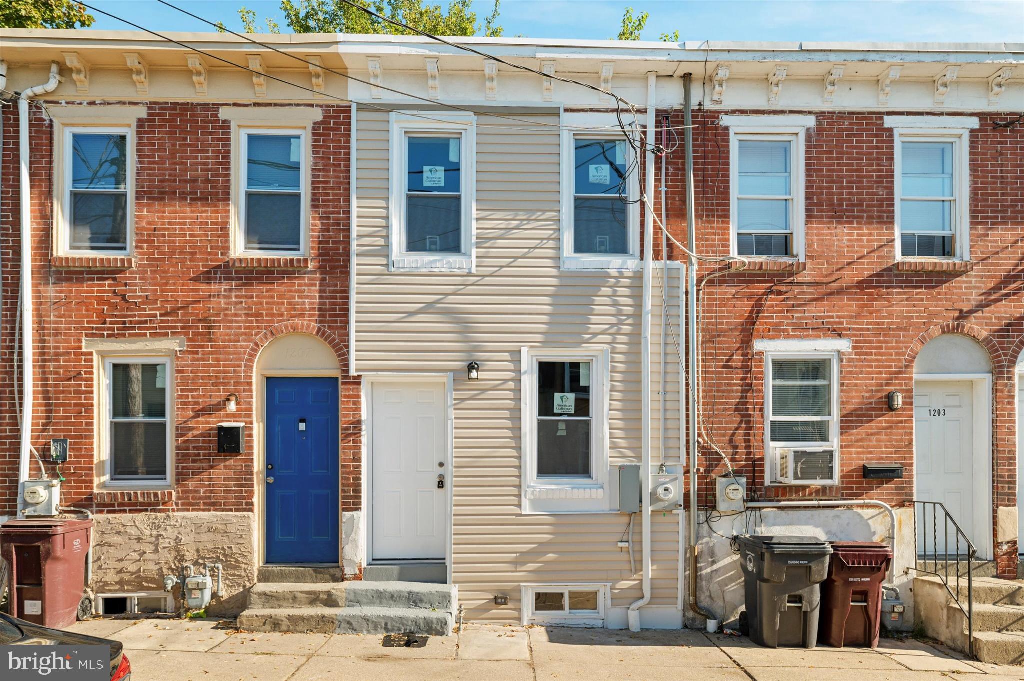 a view of a house with more windows and brick walls