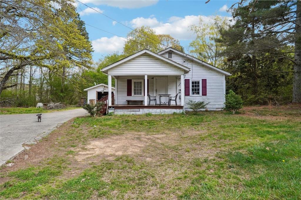 a front view of house with yard and green space