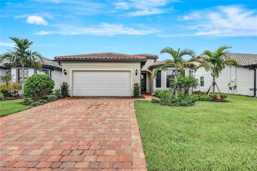 a house with a yard and palm trees