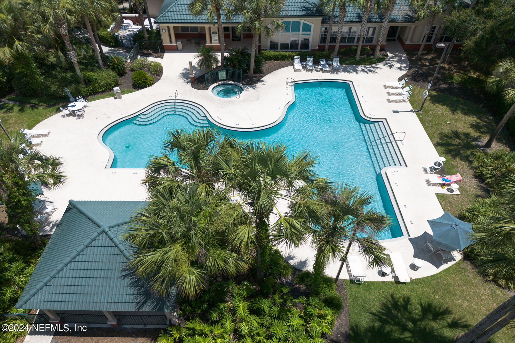 an aerial view of a house with swimming pool and patio