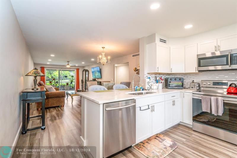 a kitchen with a sink cabinets and wooden floor