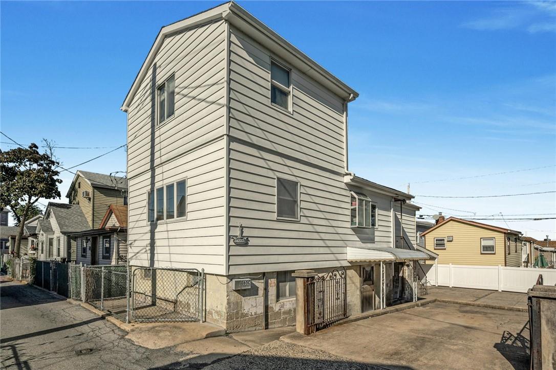 Front of home with side door and back yard