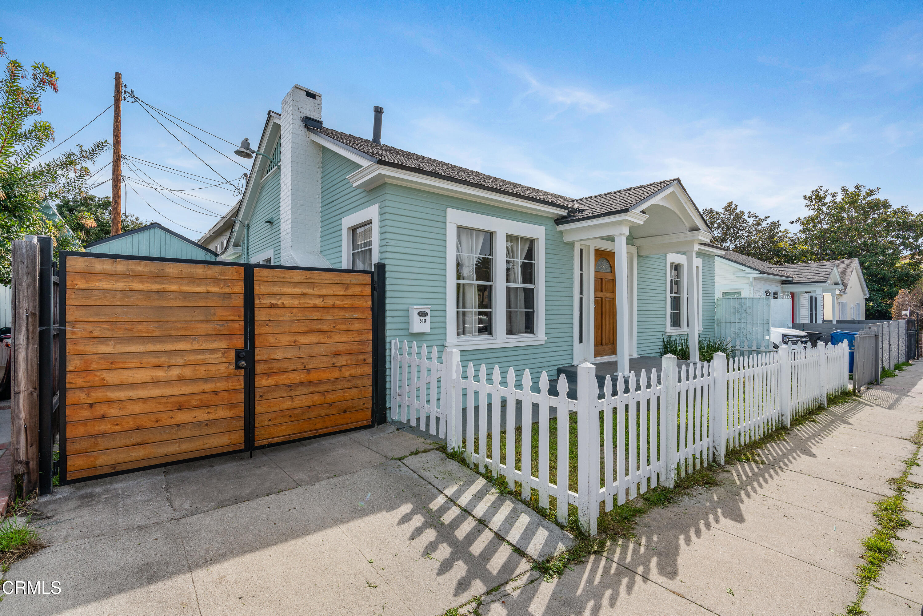 a view of a house with wooden fence