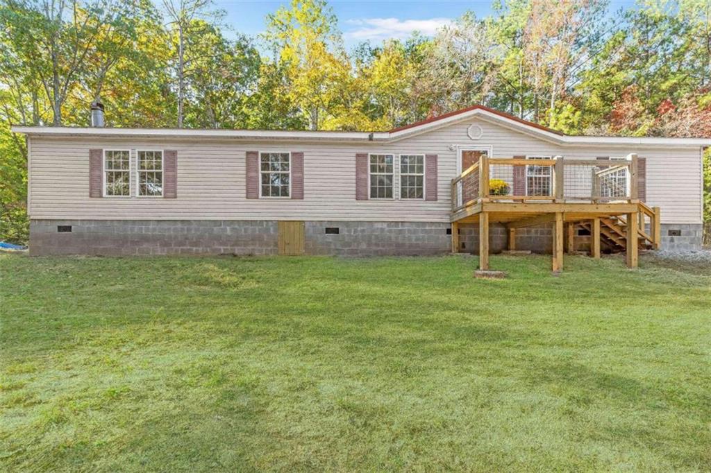 a view of a house with a yard and sitting area