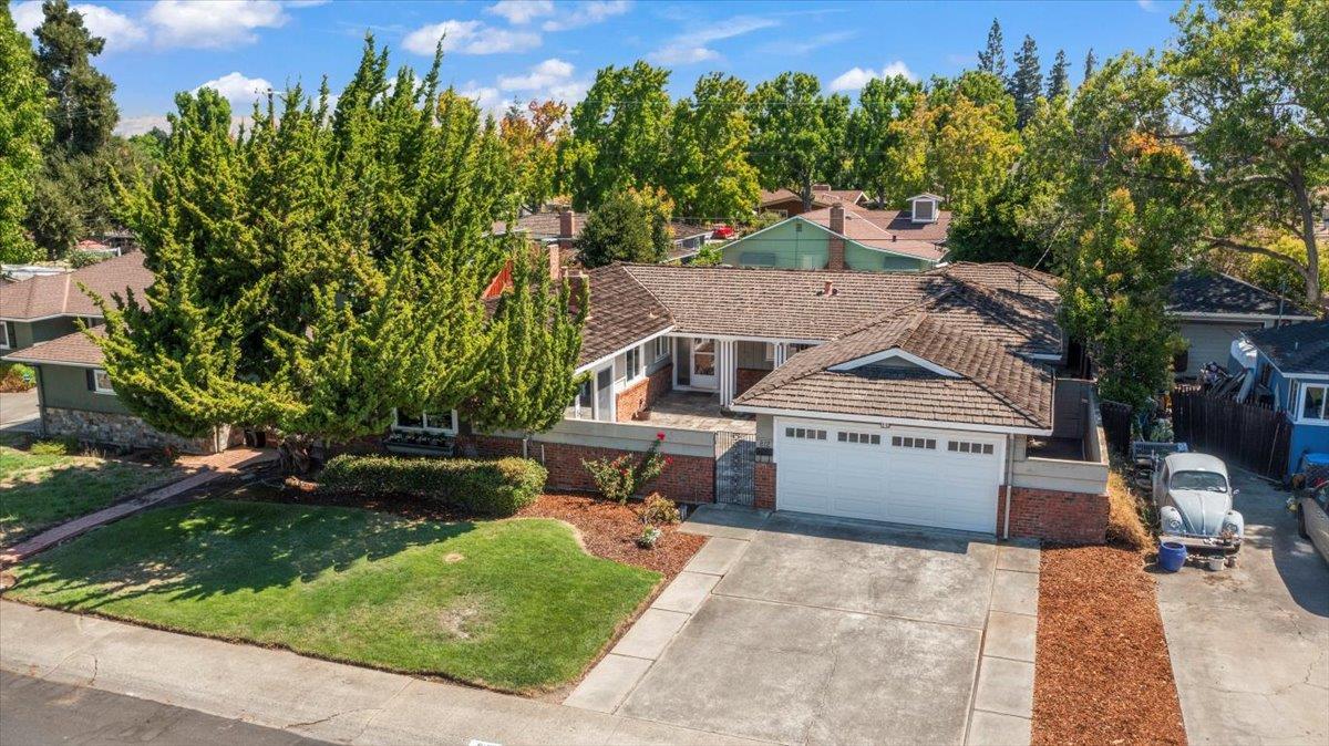 an aerial view of a house with a yard