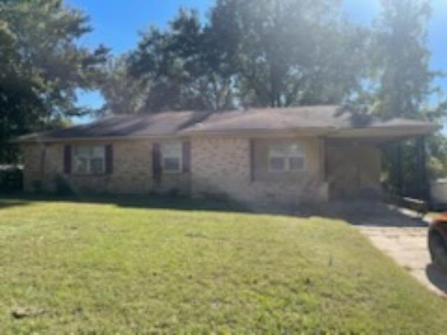 Single story home with a carport and a front lawn