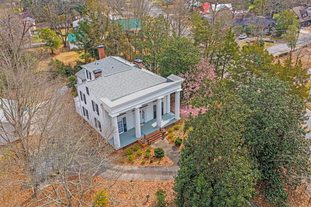 an aerial view of a house with a yard