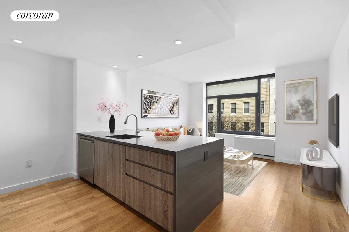 a view of living room and kitchen with wooden floor