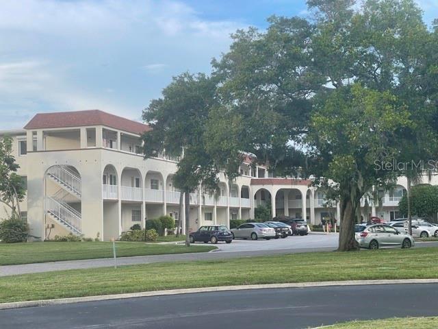 a front view of a building with a garden