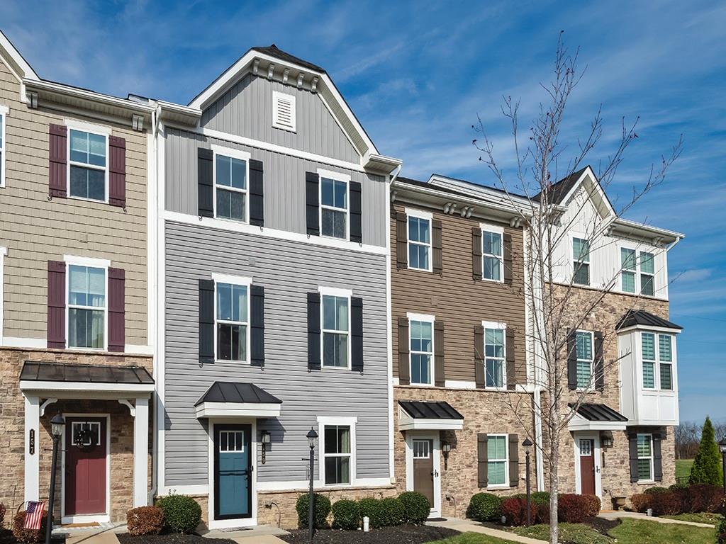 a front view of a residential apartment building with a yard