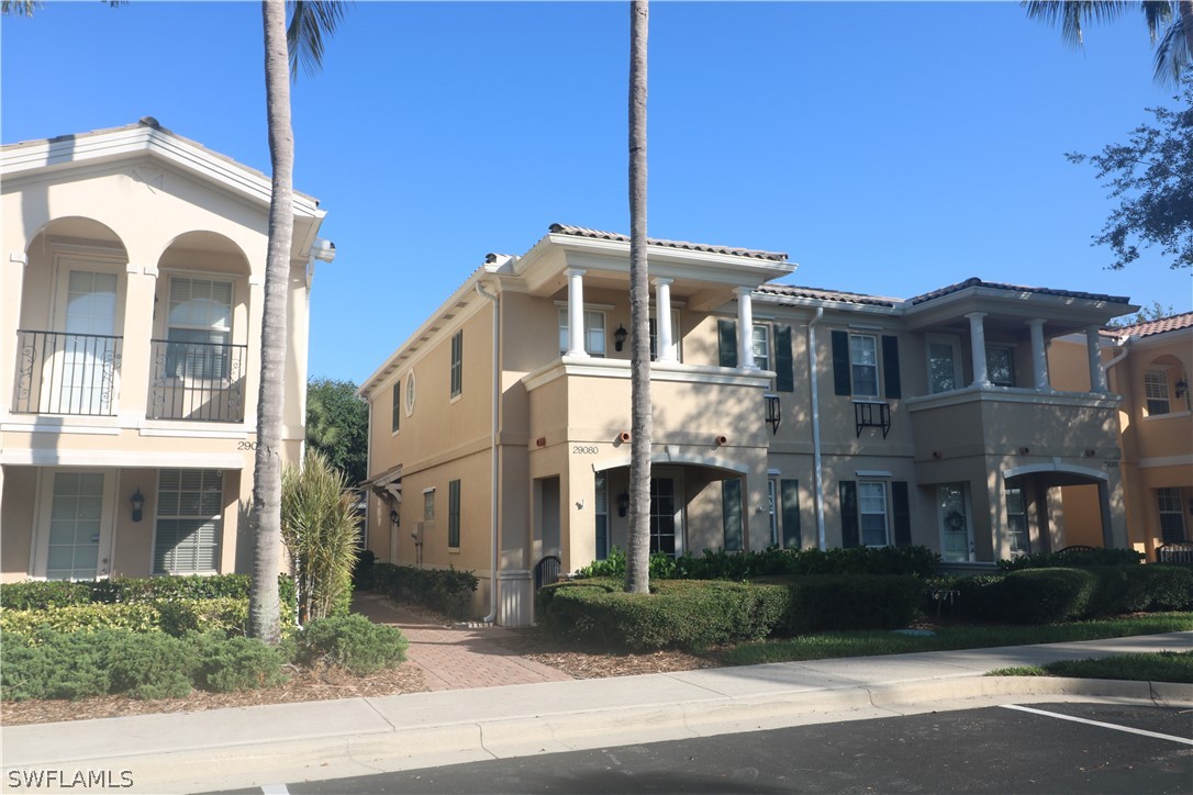 a front view of a residential apartment building with a yard