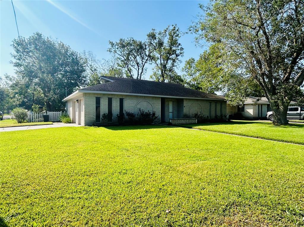 a front view of house with a garden