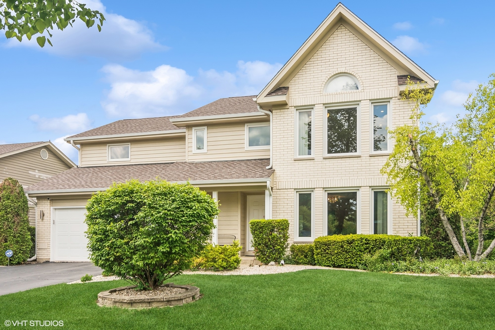 a front view of a house with a yard and garage