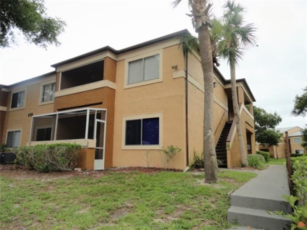 a house that has a tree in front of the house