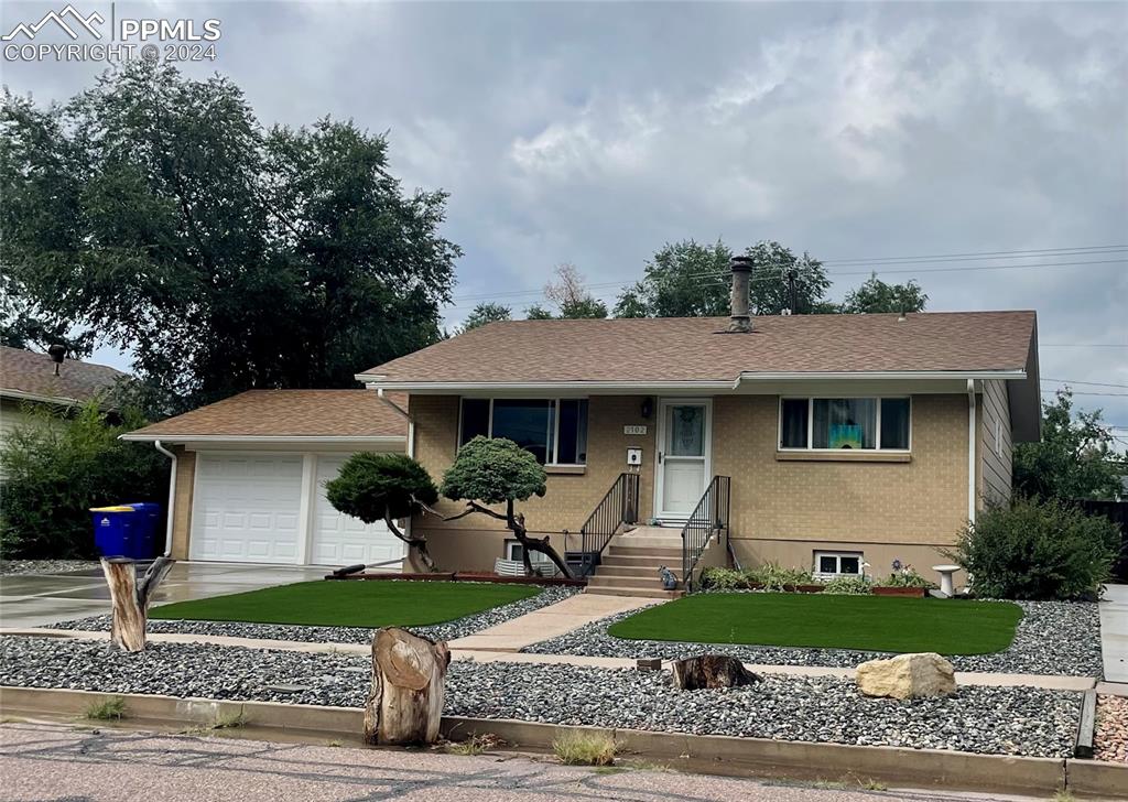 a front view of a house with a garden