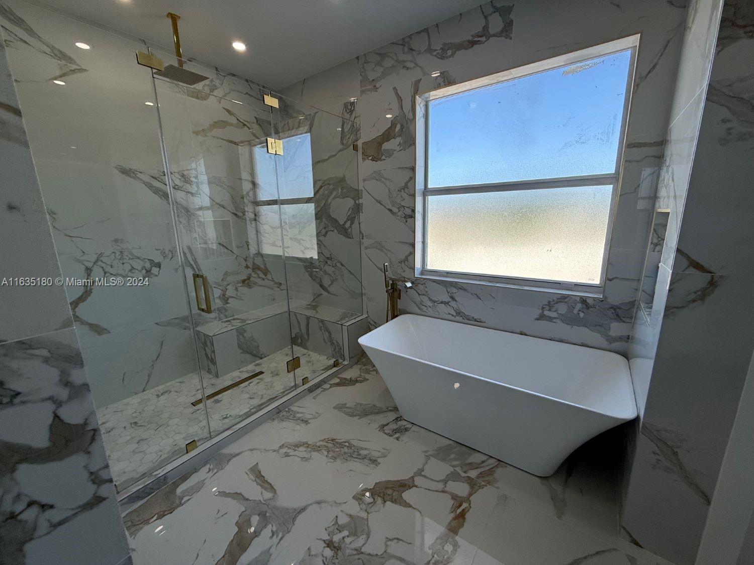 a bathroom with a bathtub and shower