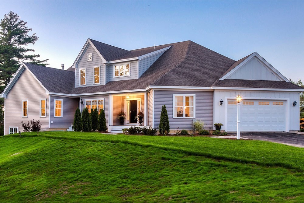 a front view of a house with a yard and garage