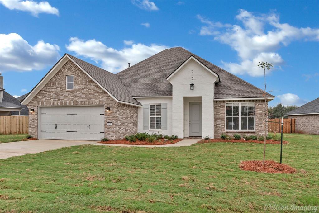 a front view of a house with a big yard