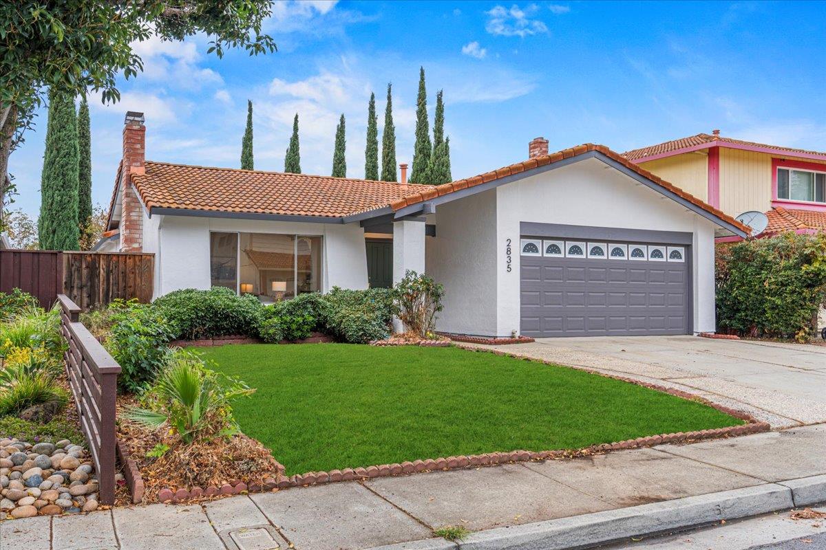 a front view of a house with a yard and garage