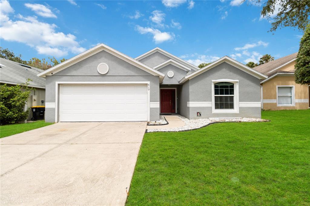 a front view of house with yard and green space