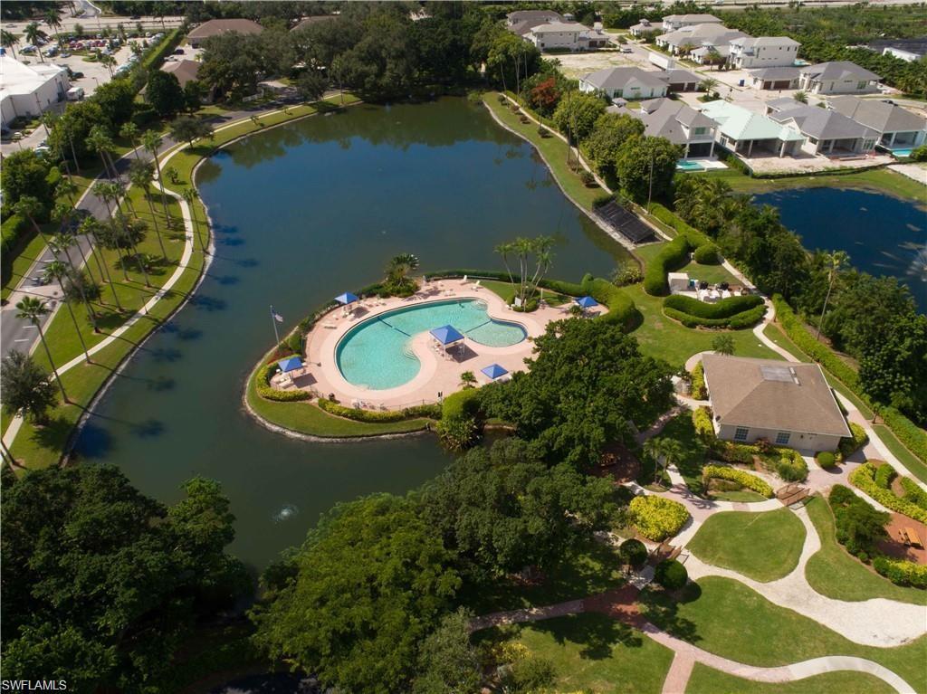 an aerial view of a house with a yard and lake view