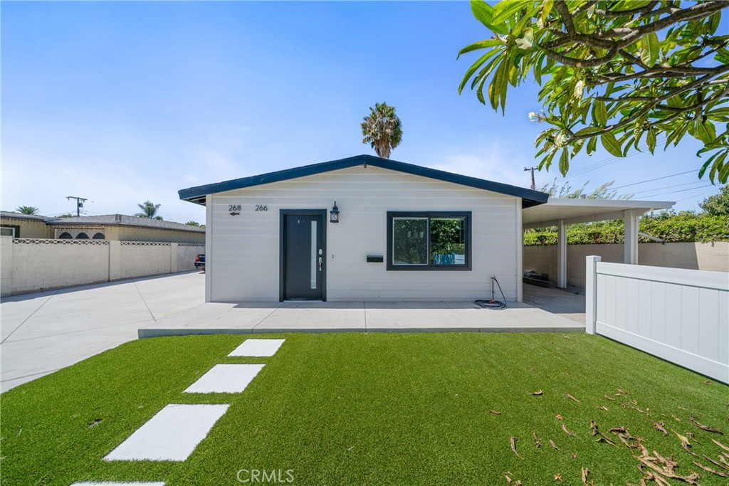 a view of a house with a yard and plants