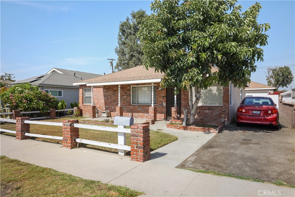 a front view of a house with a garden and patio