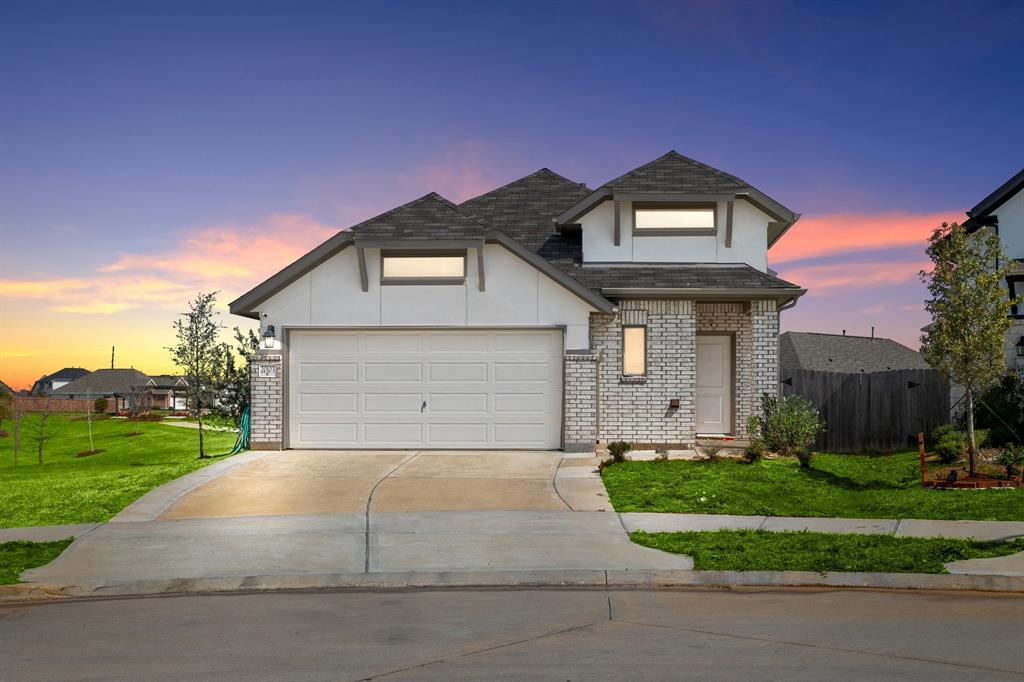 a front view of a house with a yard and garage