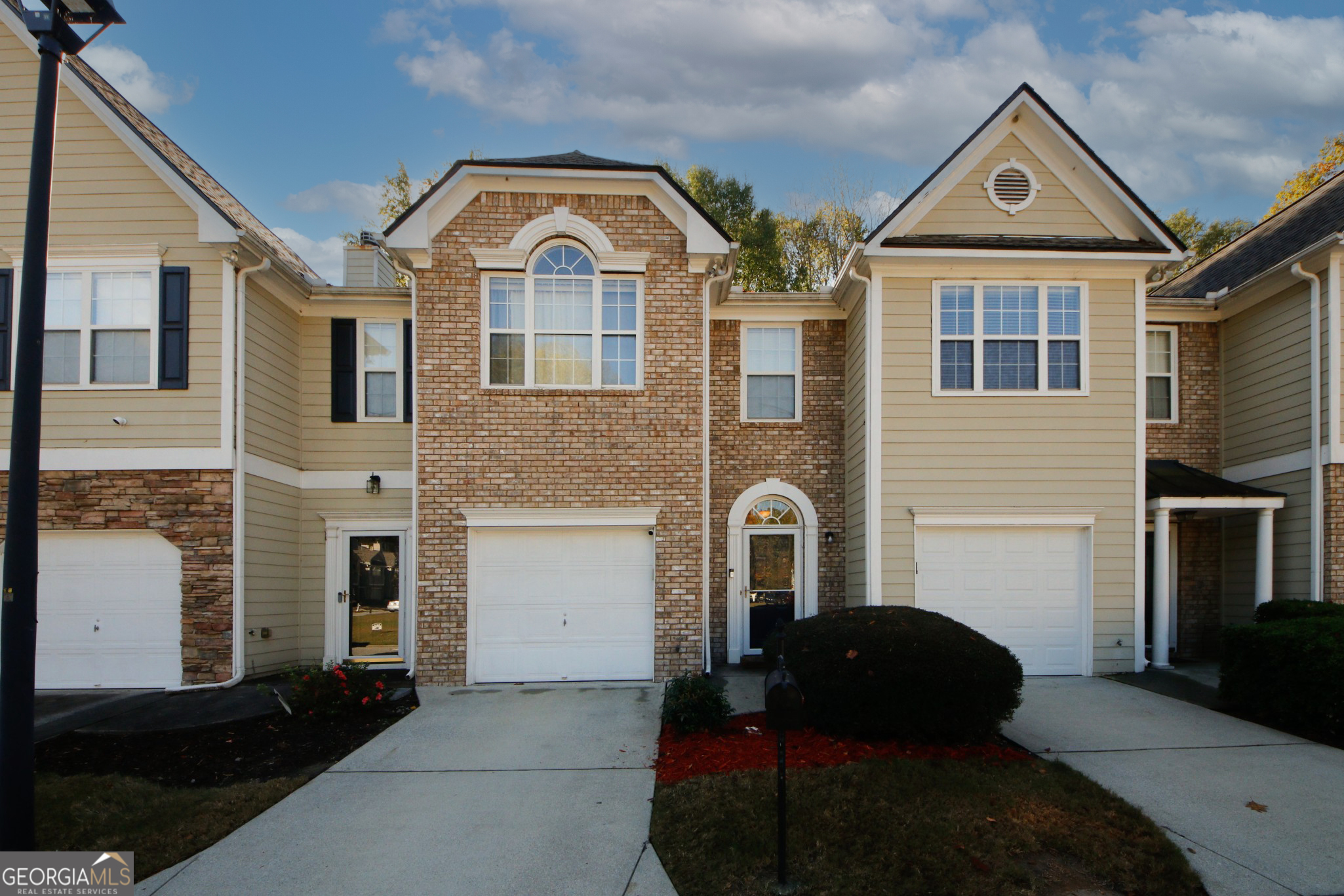 a front view of a house with a yard