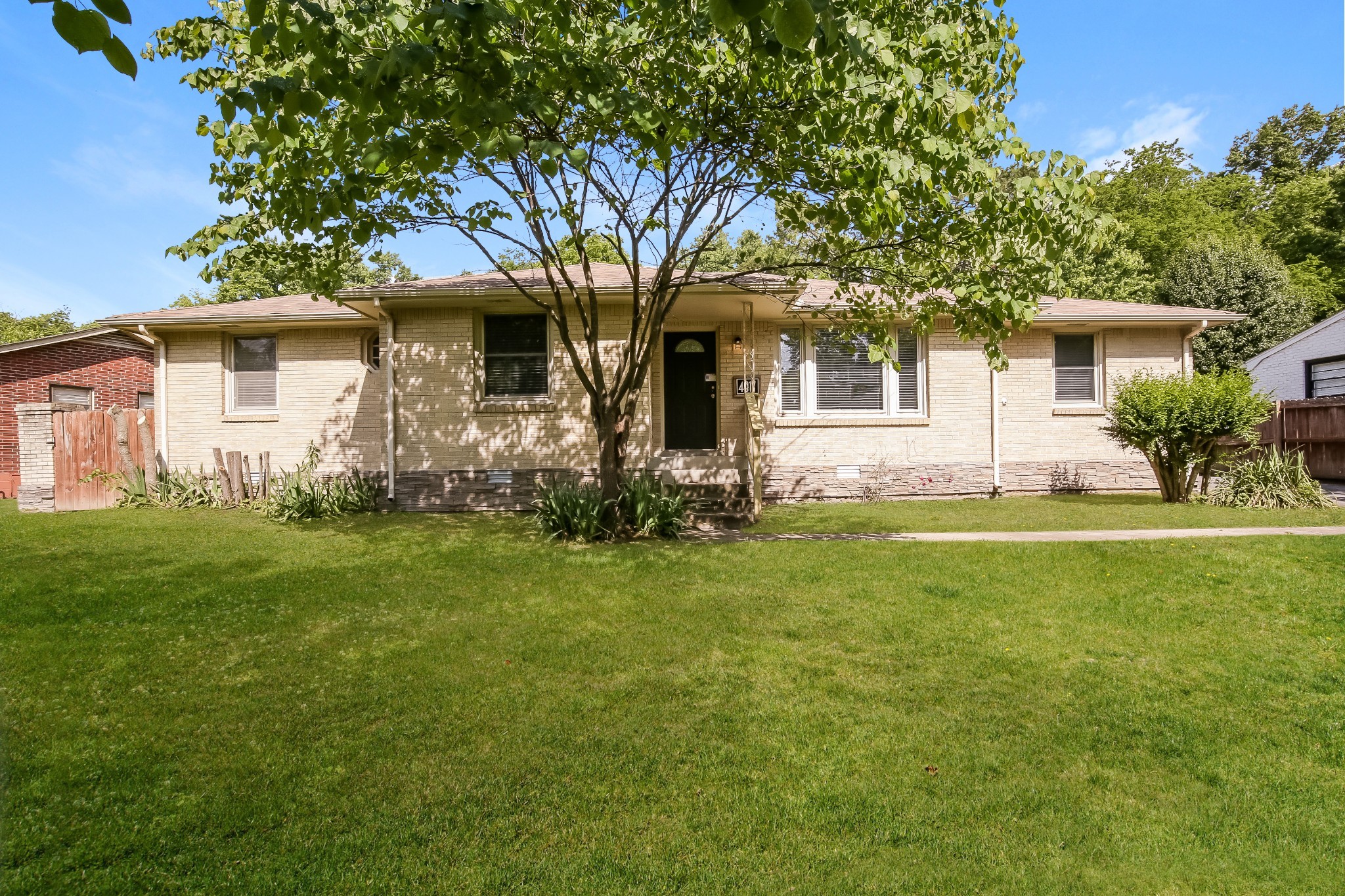 a front view of house with yard and green space