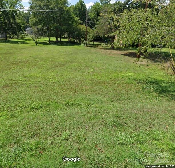 a view of a field with grass and trees