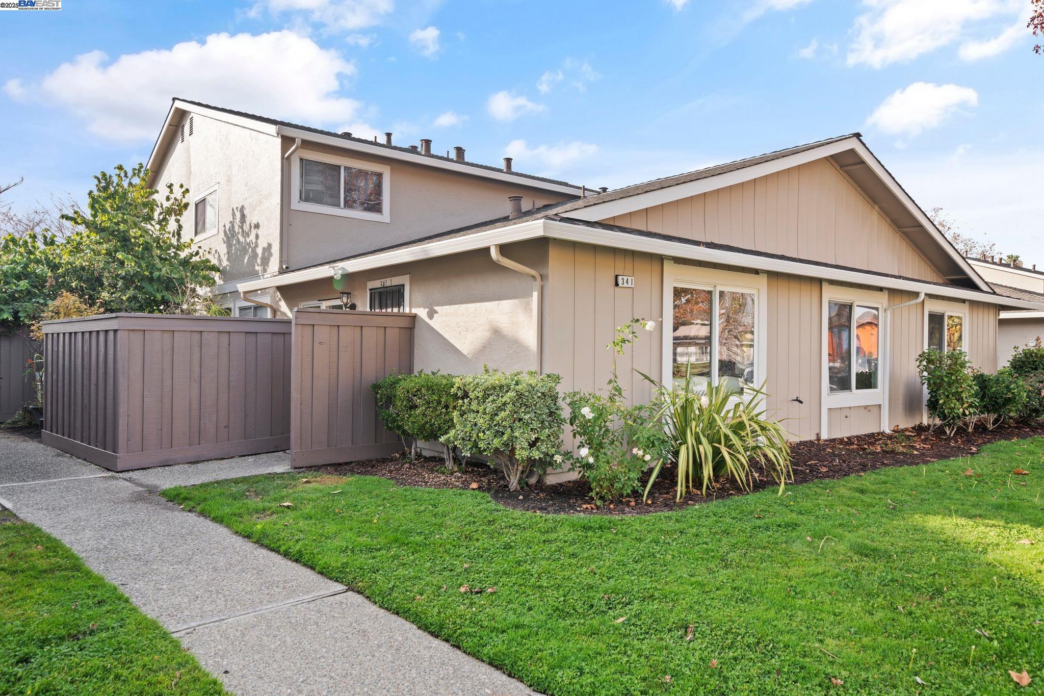 a view of a yard in front view of a house and garage