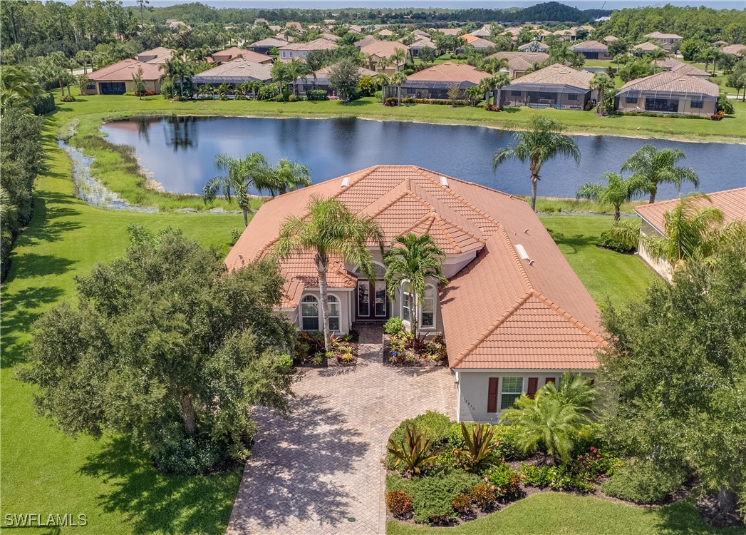 an aerial view of a house with outdoor space and lake view