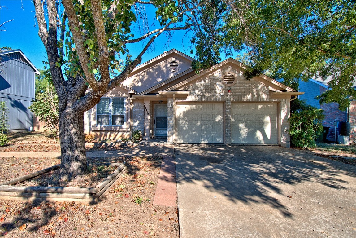 a view of a house with a tree