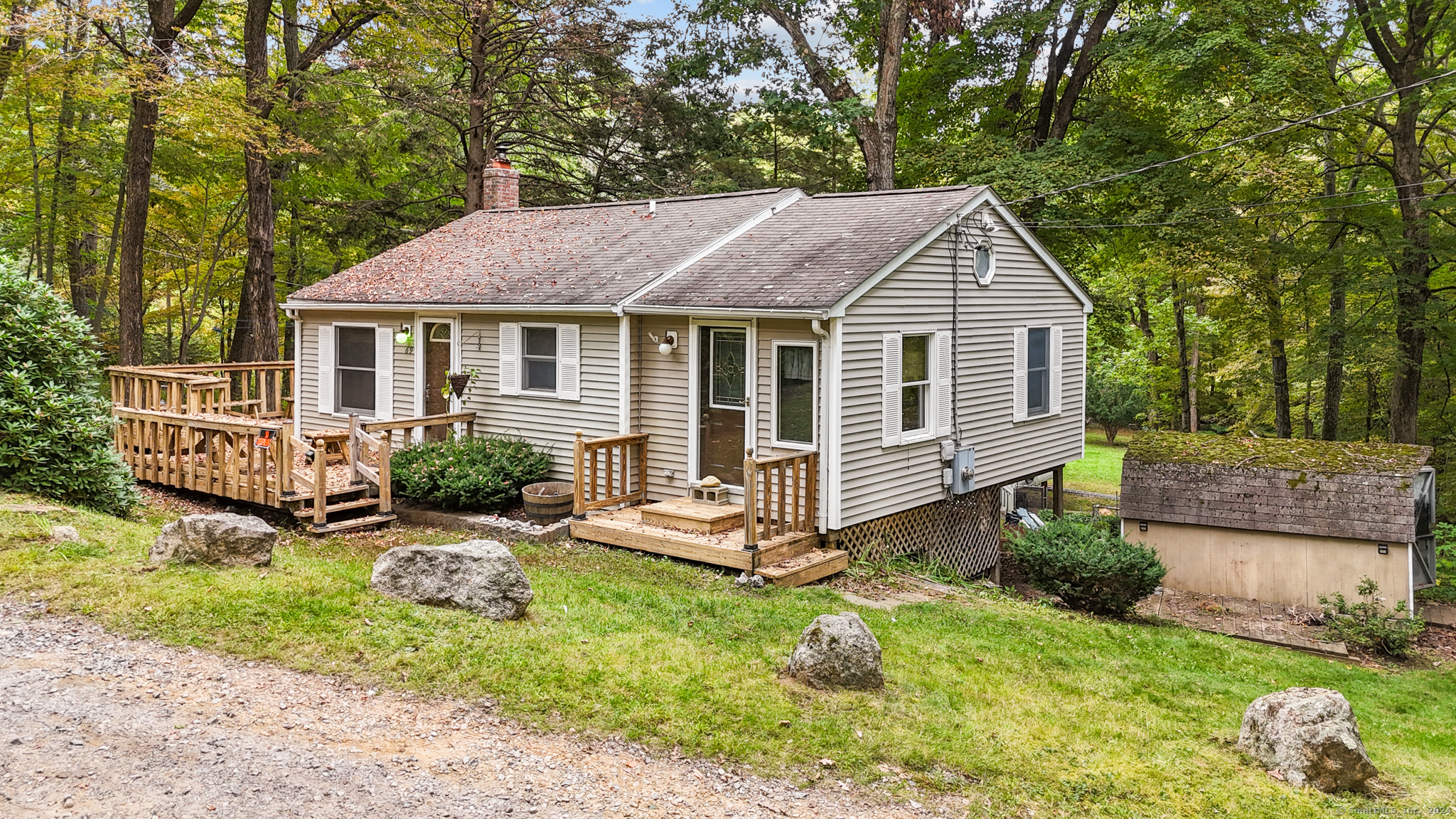 a front view of a house with a yard table and chairs