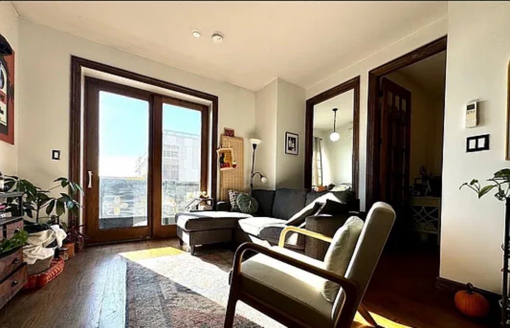 a living room with furniture and floor to ceiling windows