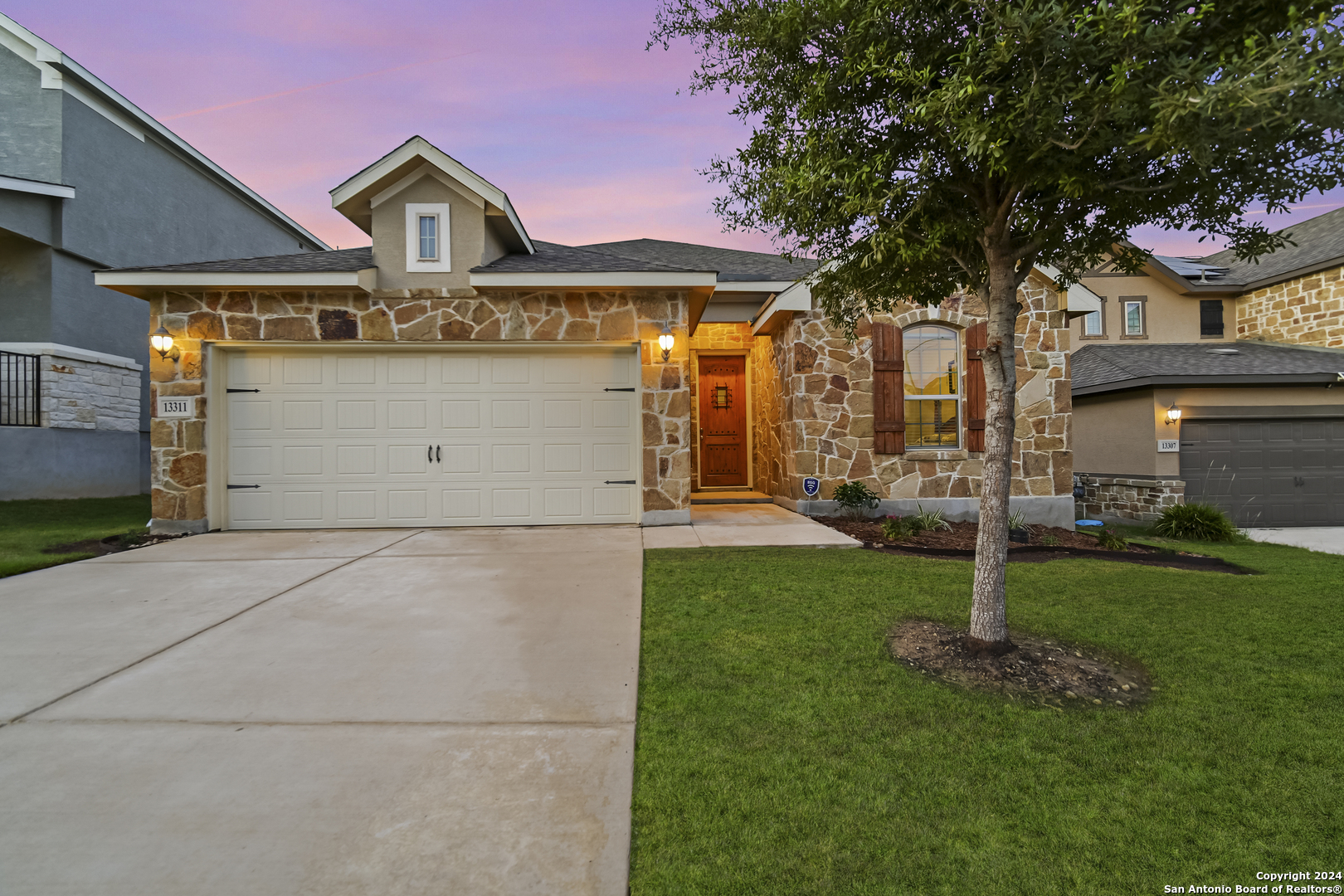 a front view of a house with a yard and garage