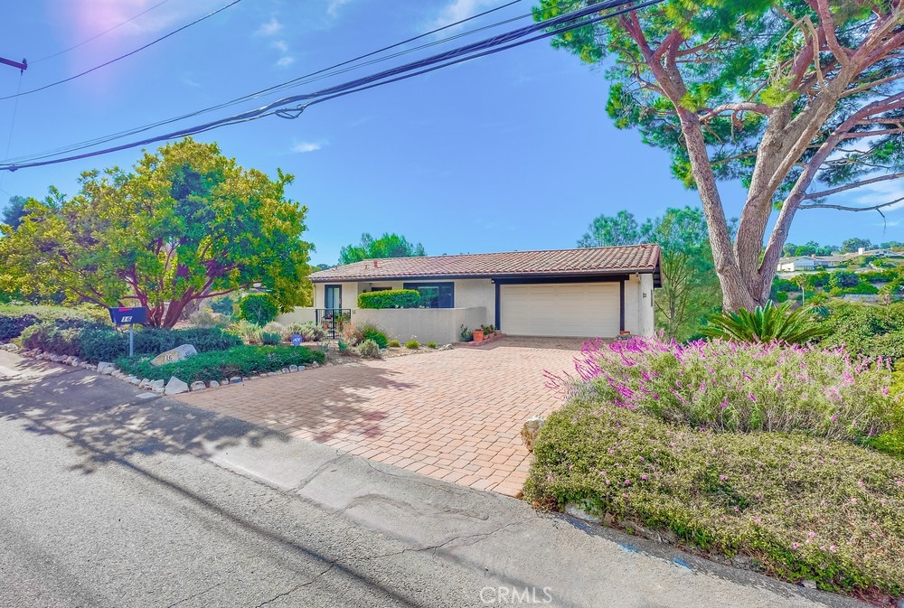 a front view of a house with a yard and a garage