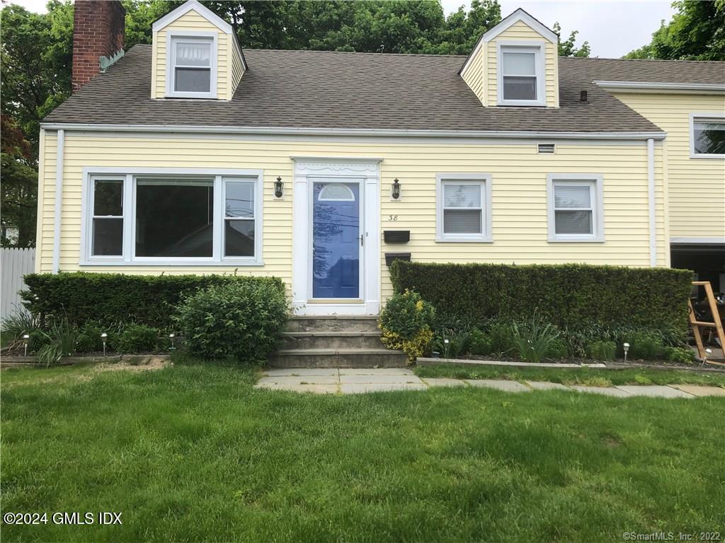 a front view of a house with a yard