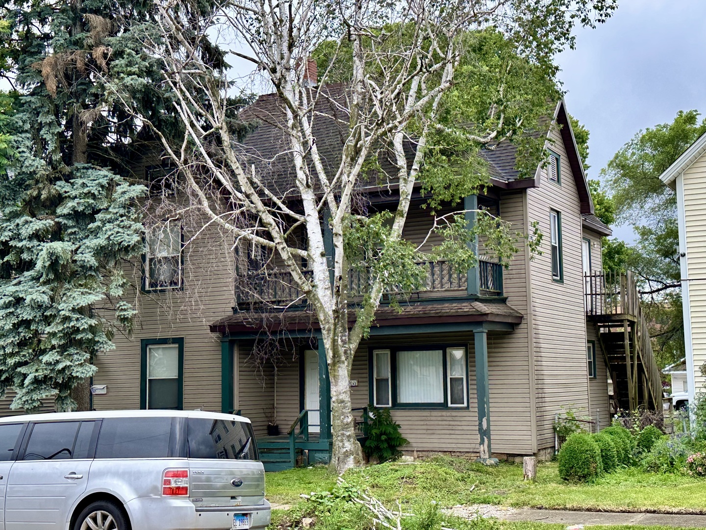 a front view of a house with a garden