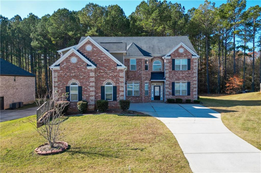 a view of house with yard in front of house