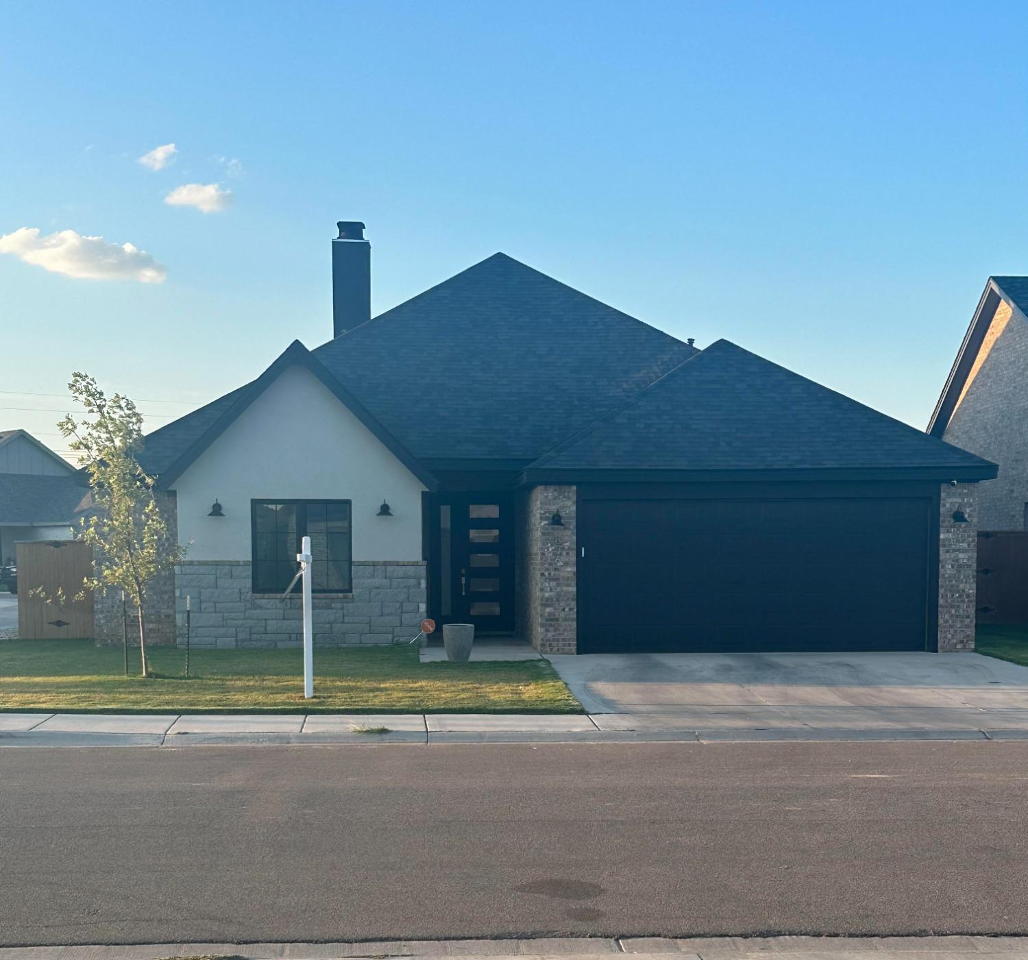 a view of a house with a backyard and a yard