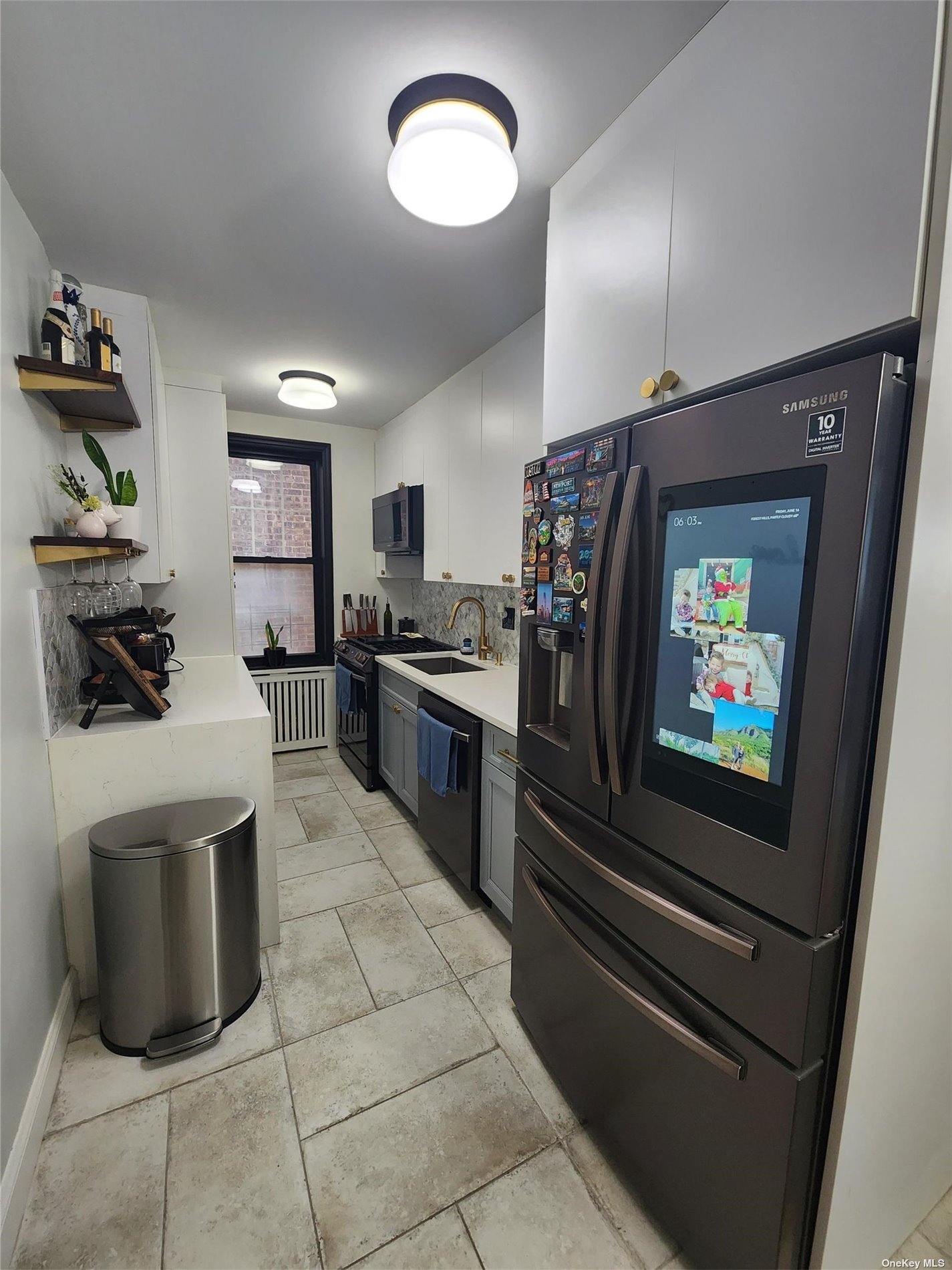 a kitchen with stainless steel appliances kitchen island granite countertop a refrigerator and a stove top oven