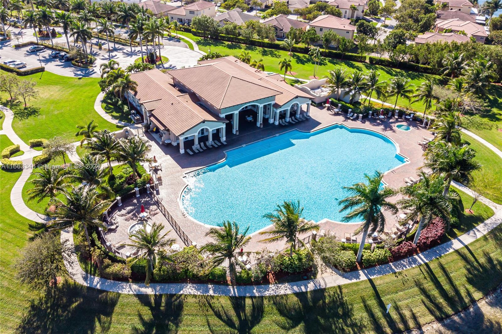 an aerial view of residential houses with outdoor space and swimming pool