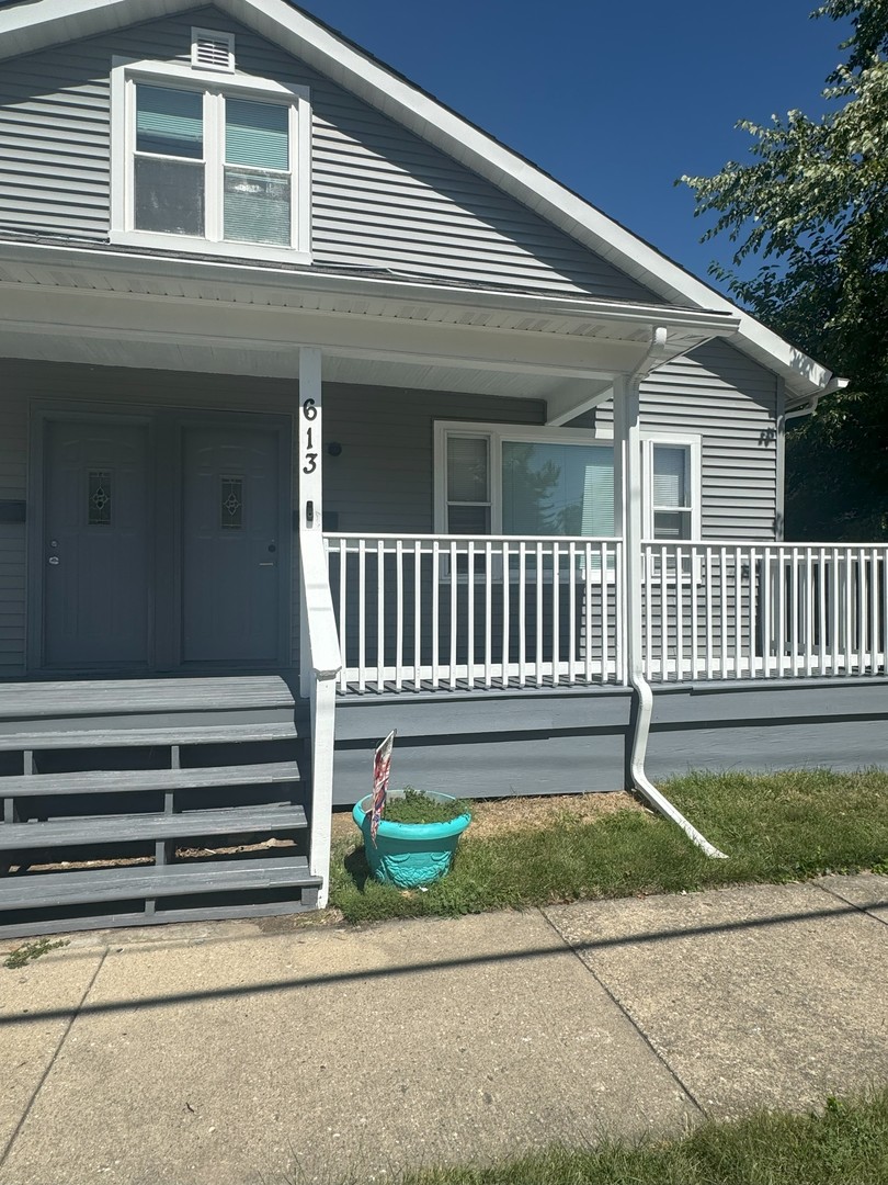 a white bench sitting in front of a house