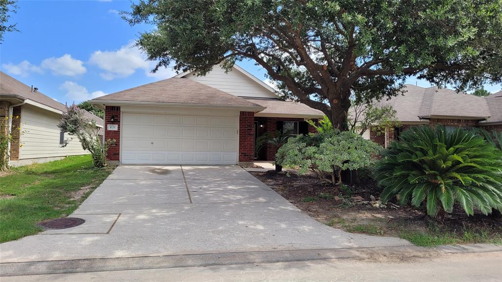 a front view of a house with a yard and a garage