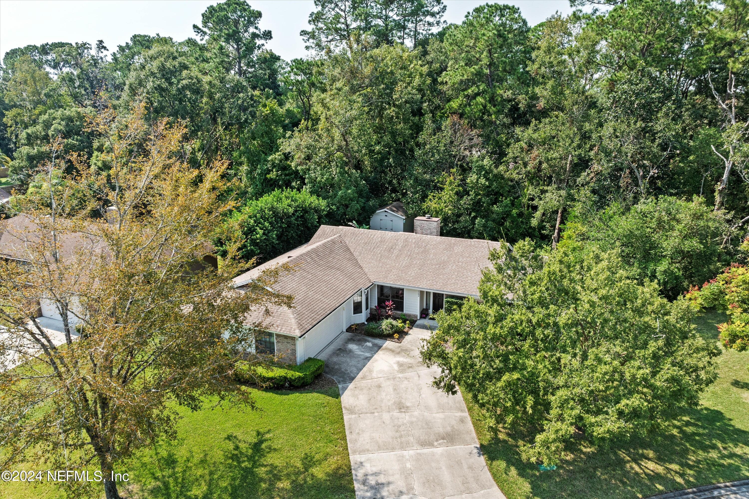 an aerial view of a house with yard and outdoor seating